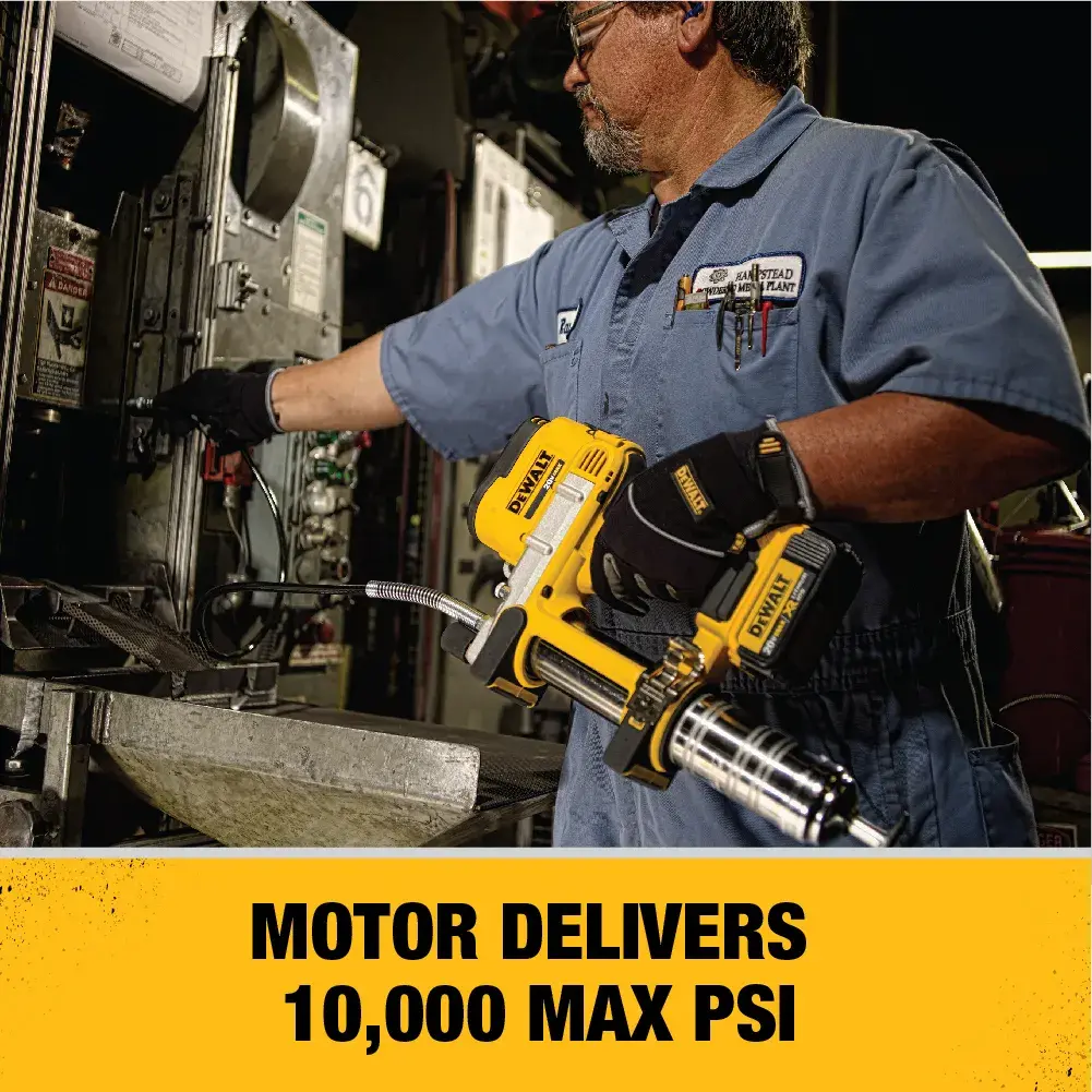 A person is using a DEWALT DCGG571M1 grease gun with a 42-inch long and flexible hose to lubricate a large yellow industrial machine. The person's face is blurred for privacy and the image highlights the tool's hose length and flexibility.