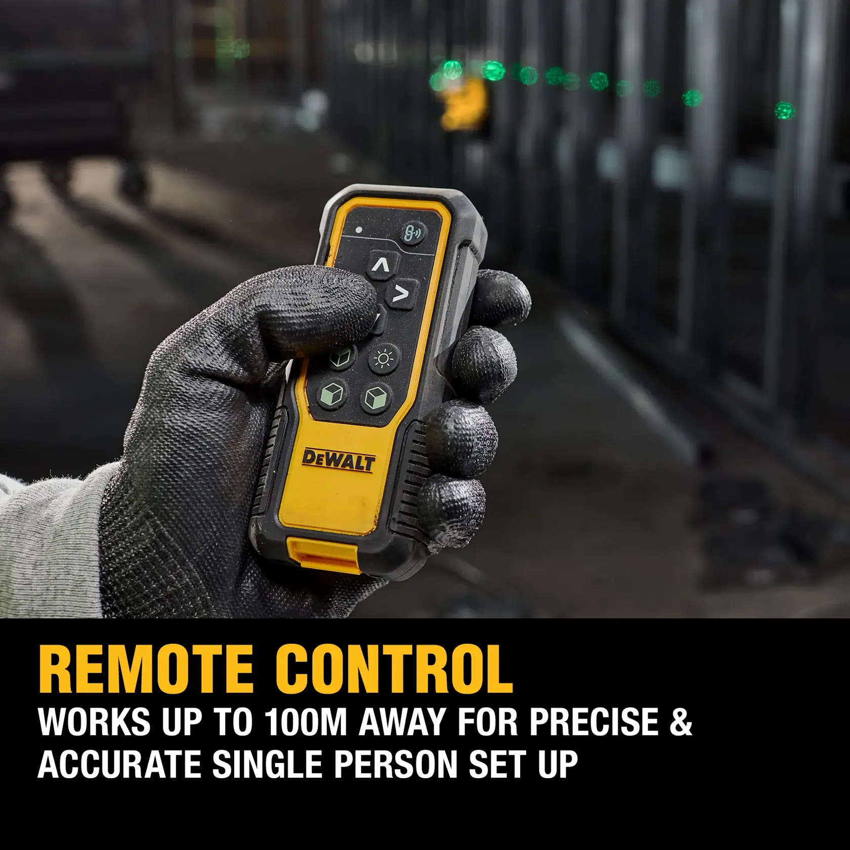DEWALT laser level with green beam on tripod at construction site, worker and scaffolding in background.