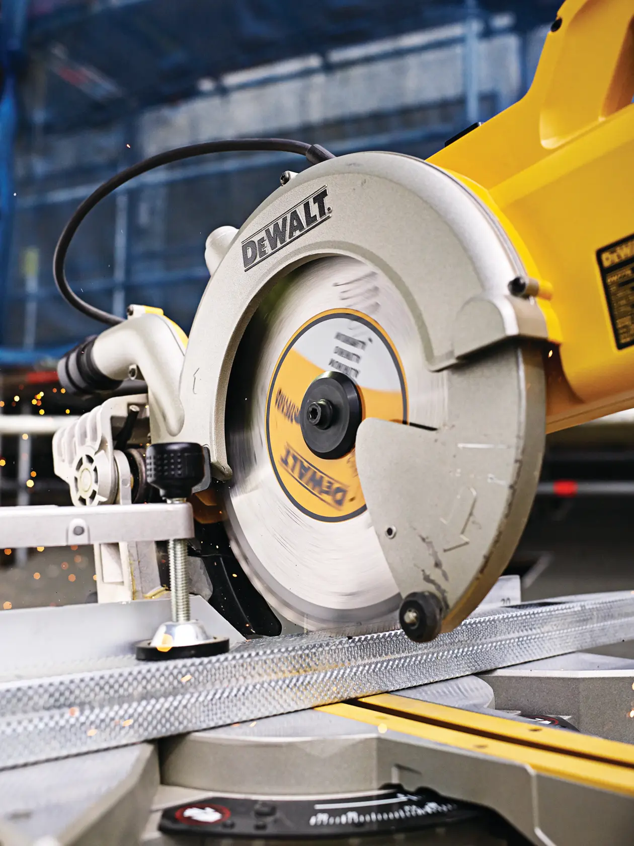 DEWALT circular saw cutting metal on a workbench; close-up of the blade in action.