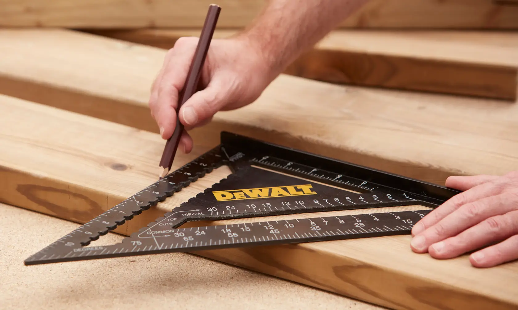 A black DEWALT triangular carpenter's square with various measurement markings and conversion tables printed in white on its surface.