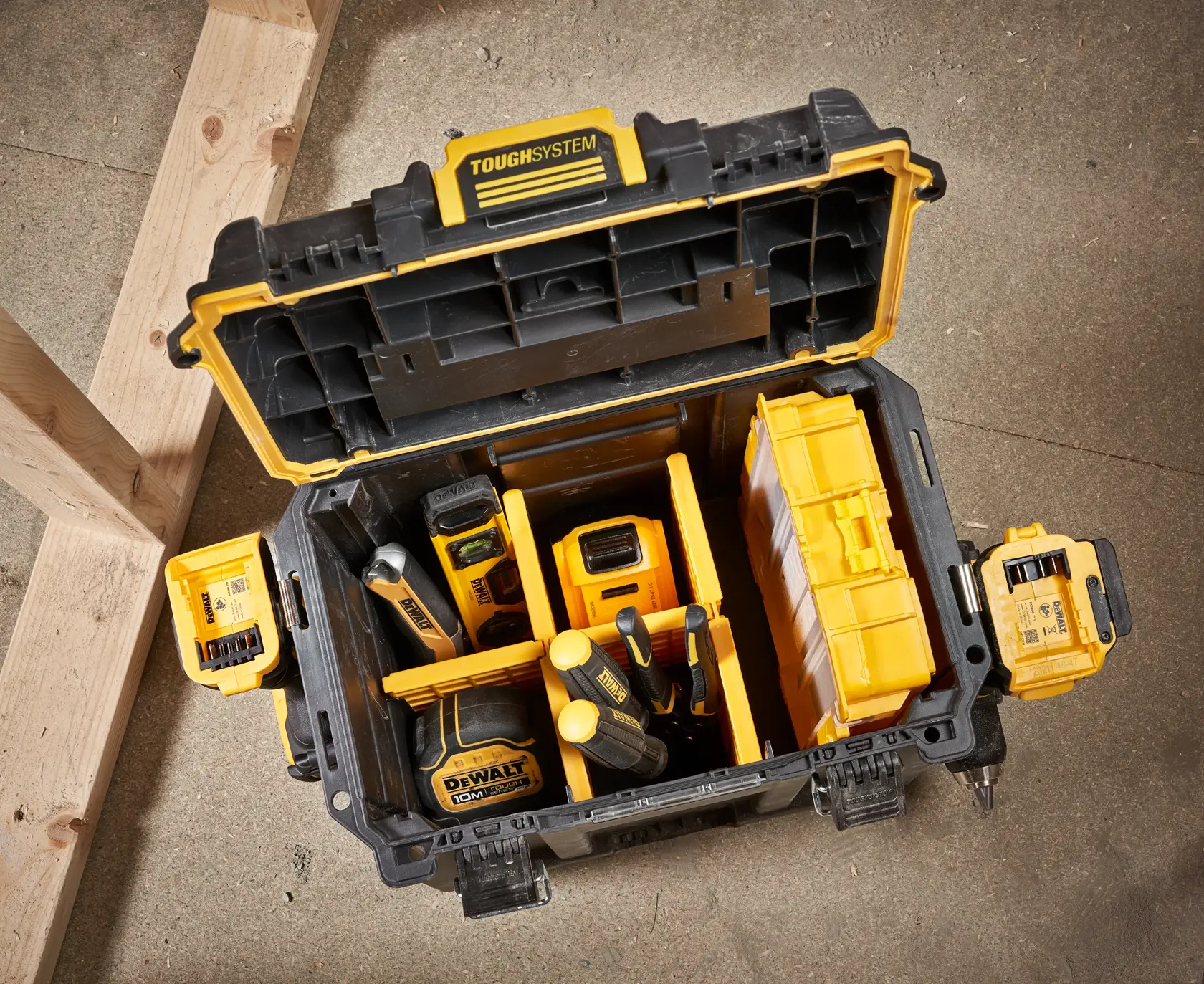 Photo of open DEWALT DWST08035-1 ToughSystem toolbox with organized yellow and black tools inside, top-down view.