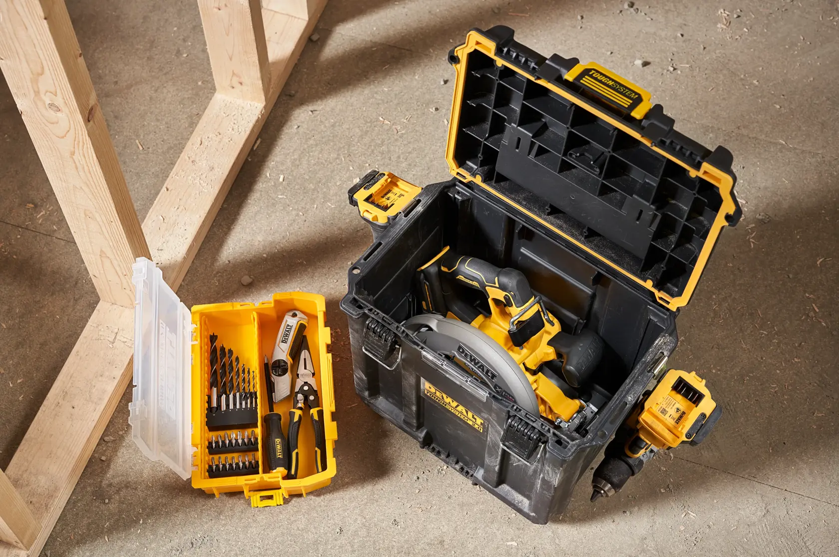DEWALT DWST08035-1 toolbox with circular saw and yellow organizer tray with drill bits and pliers on floor.