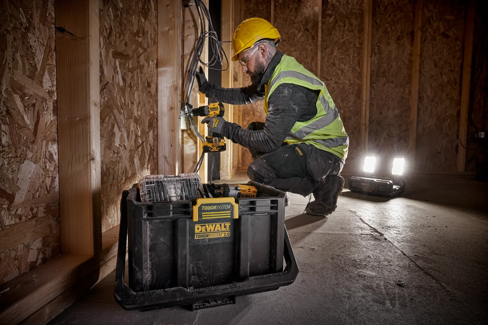 DEWALT ToughSystem 2.0 Werbegrafik mit dem Slogan 'Storage Built to Handle It' in großen, gelben Buchstaben auf einem dunklen, strukturierten Hintergrund.