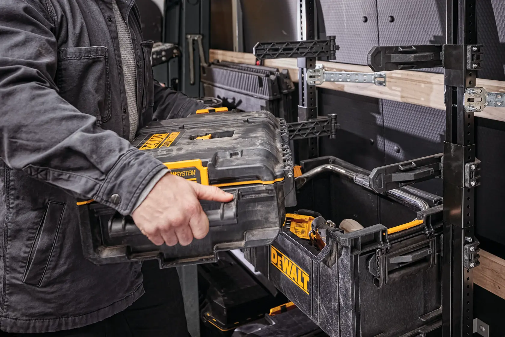 DEWALT ToughSystem 2.0 promotional graphic with the slogan 'Storage Built to Handle It' in large, bold yellow lettering on a dark, textured background.