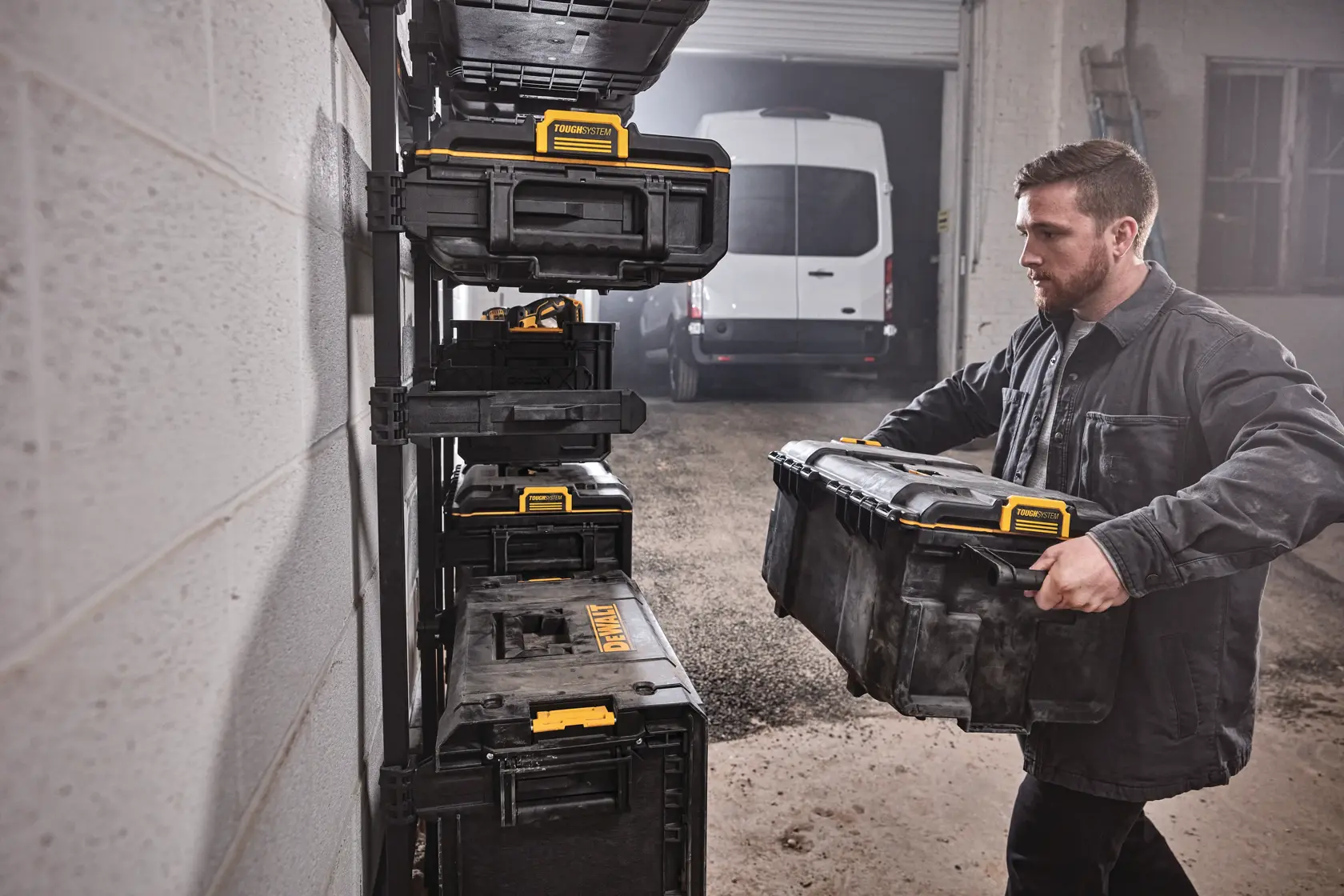 DEWALT ToughSystem 2.0 promotional graphic with the slogan 'Storage Built to Handle It' in large, bold yellow lettering on a dark, textured background.
